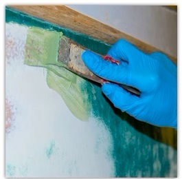 Close up of applying epoxy fairing compound on boat hull
