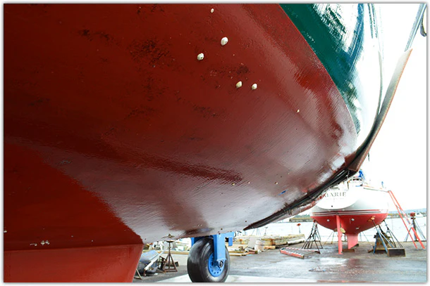 Red bottom paint on boat in shipyard