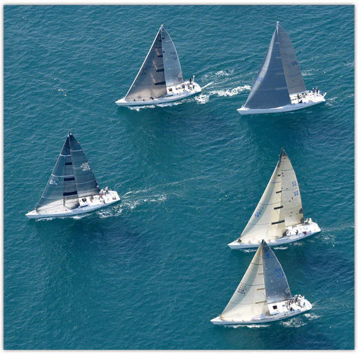 5 Sailboats Racing on the Open Ocean