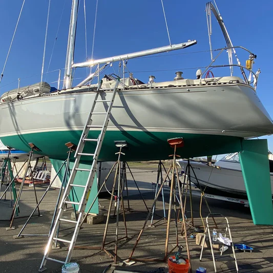 Boat up on stands during bottom painting on a sunny day