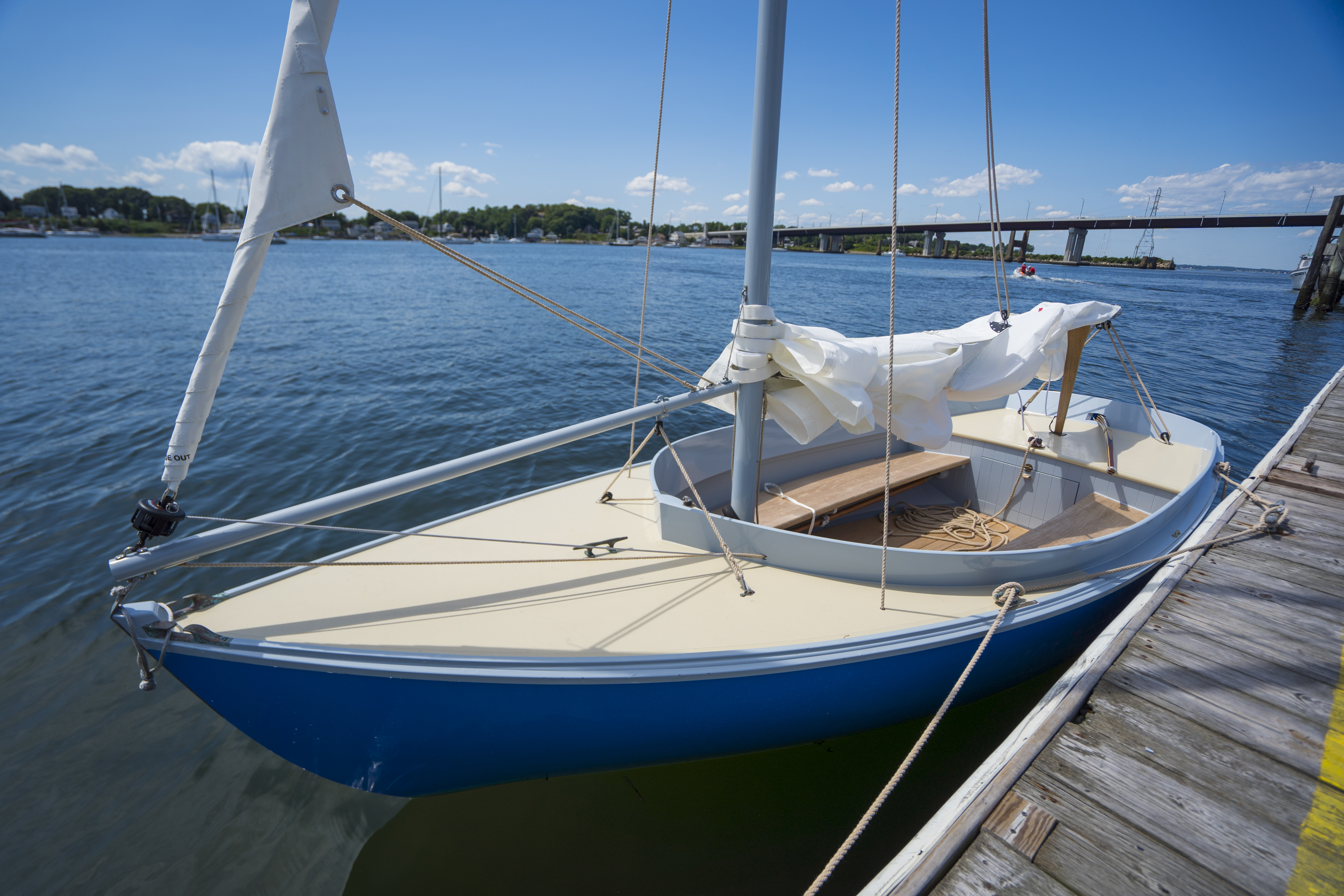 Sailboat in water with topside paint shown on hull and deck